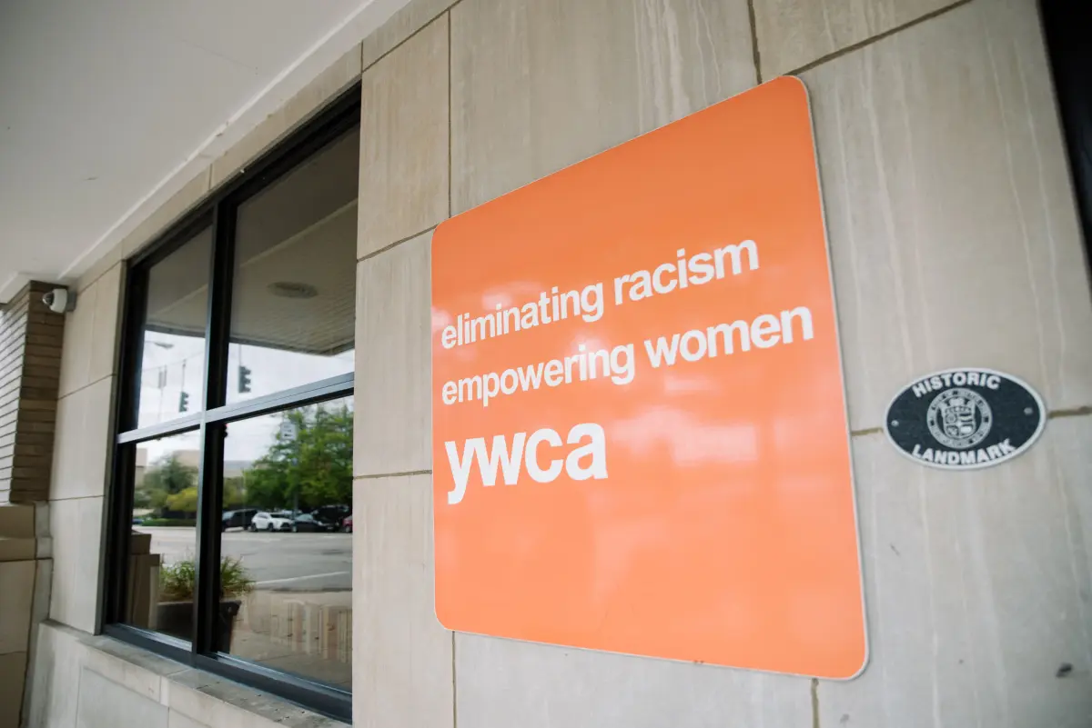 Sign displaying the YWCA logo outside of the YWCA Dayton building